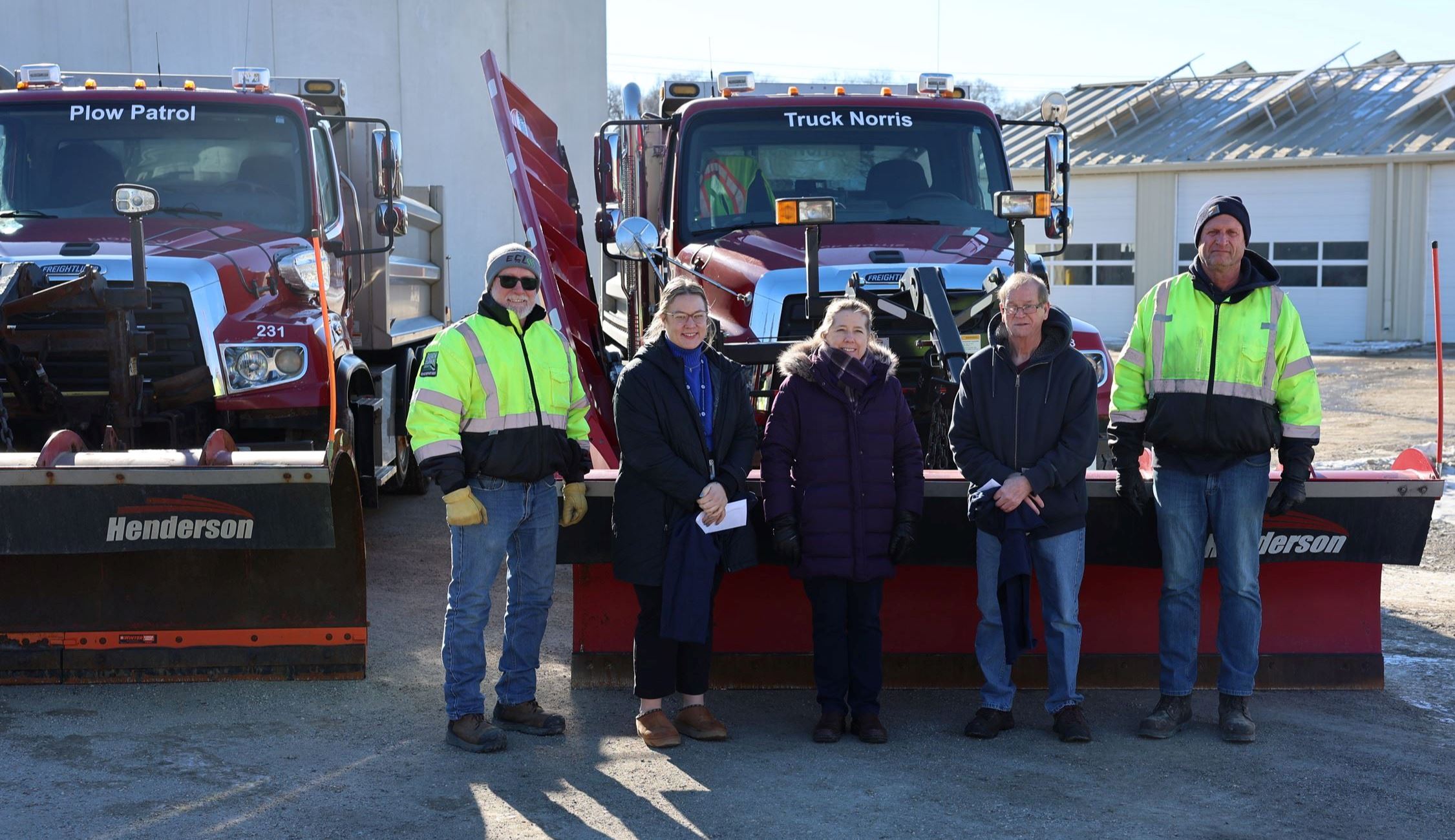 Two contest winners posing with 3 Road employees